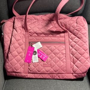 Vera Bradley Performance Twill Lay-Flat Duffel in pink.